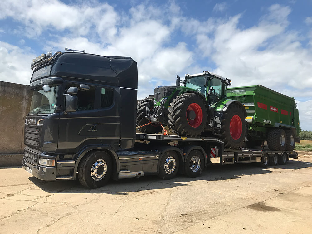 Bergmann spreader and fends tractor on a low loader for demo