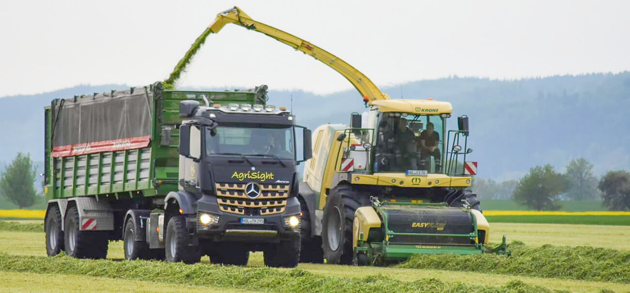 Bergmann Silage trailer and mercedes agrotruck. grass silage harvest working alongside Krone forage harvester